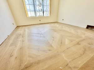 Light wood-finish flooring featuring a herringbone pattern