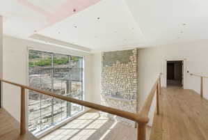 Spacious interior featuring a stone-clad fireplace and a prominent large window
