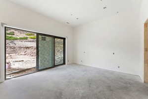 Spacious interior with concrete flooring and white walls