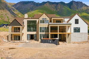 Contemporary multi-level residence featuring a stone facade and extensive window walls