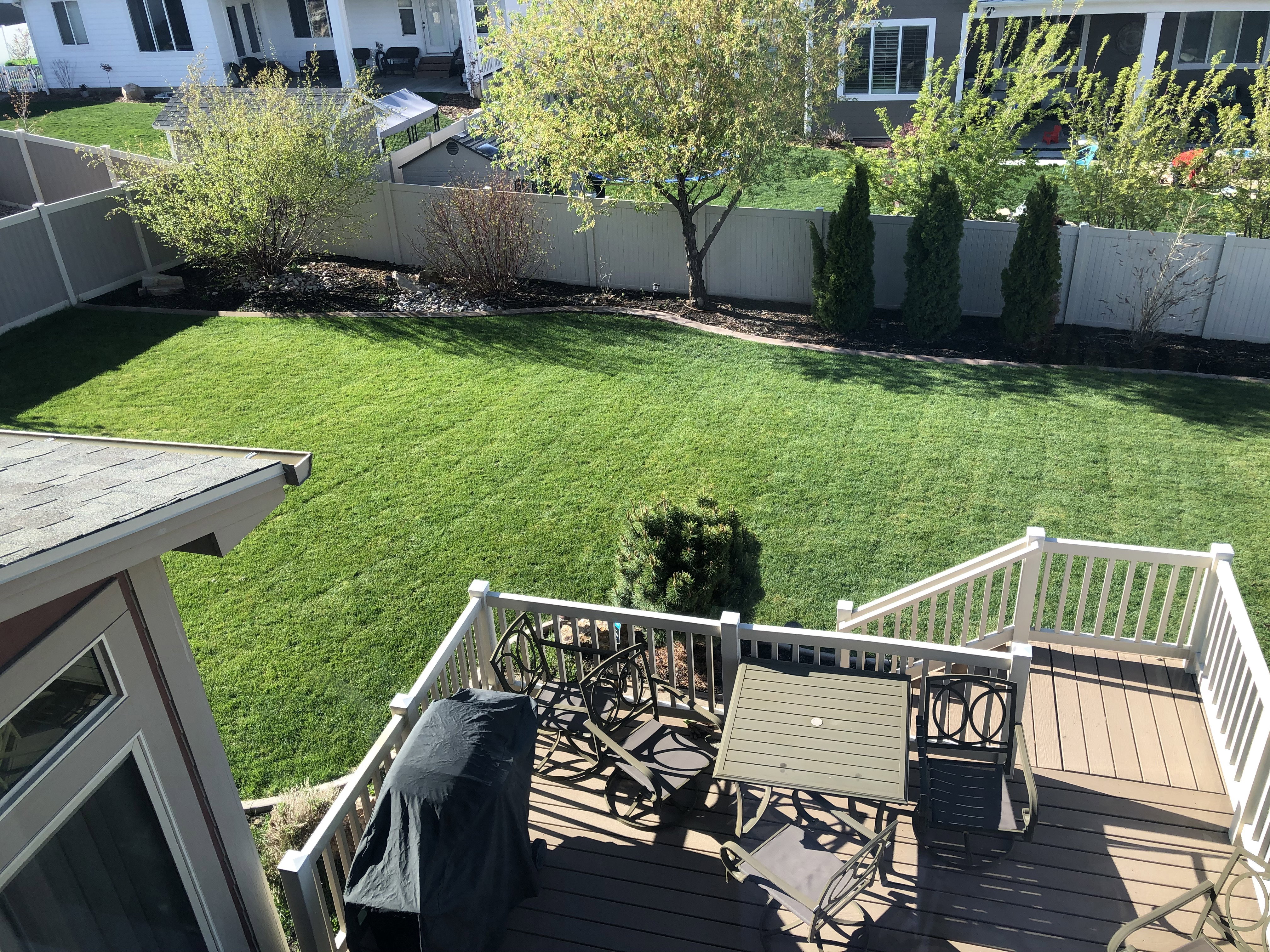 Spacious outdoor deck featuring composite decking and white railings