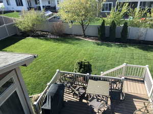 Spacious outdoor deck featuring composite decking and white railings