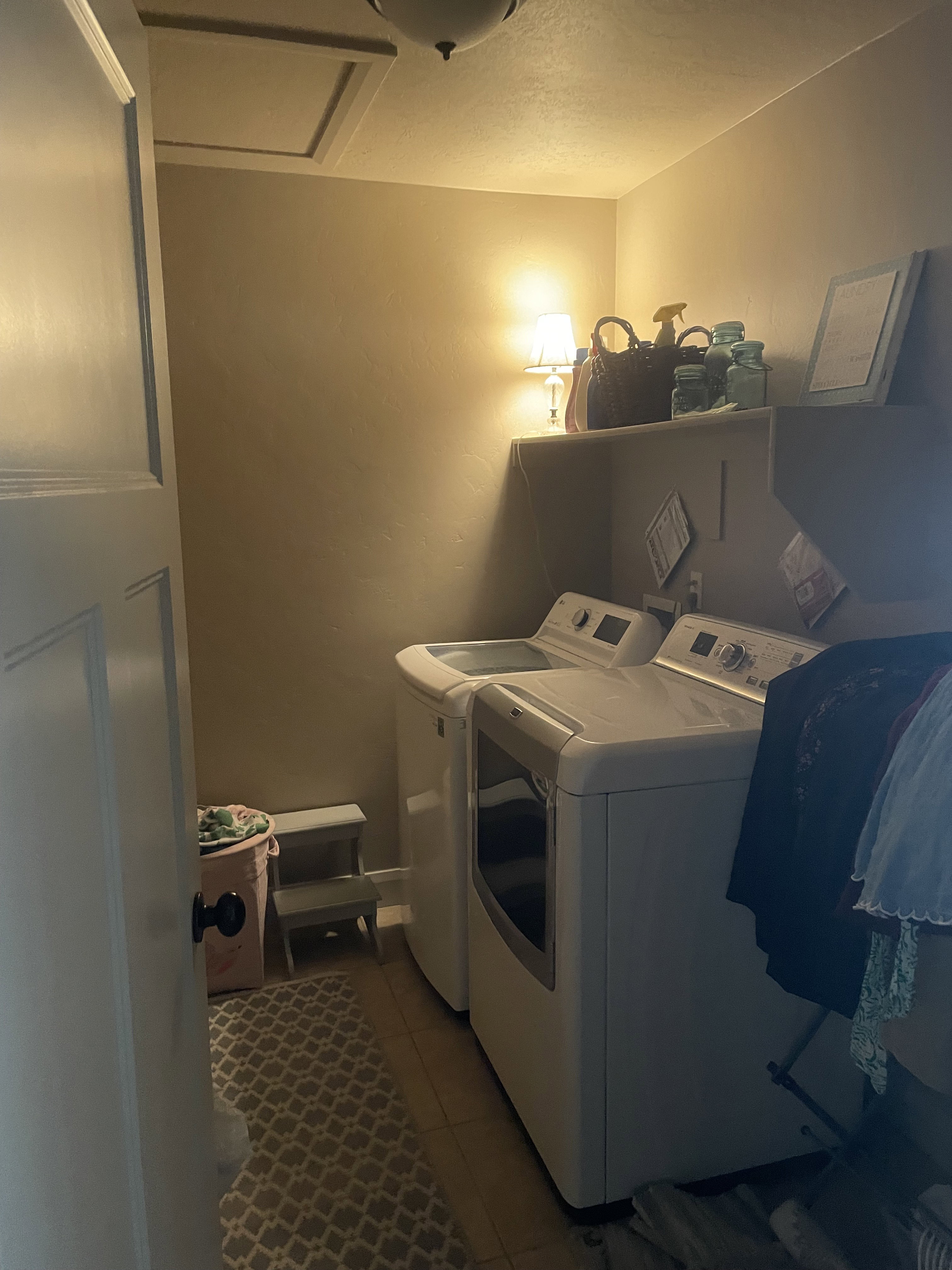 Laundry area featuring wood-finish flooring, a built-in overhead shelf, and a ceiling-mounted light fixture