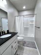 Bathroom featuring a white vanity with black countertop, undermount sink, and brushed nickel faucet