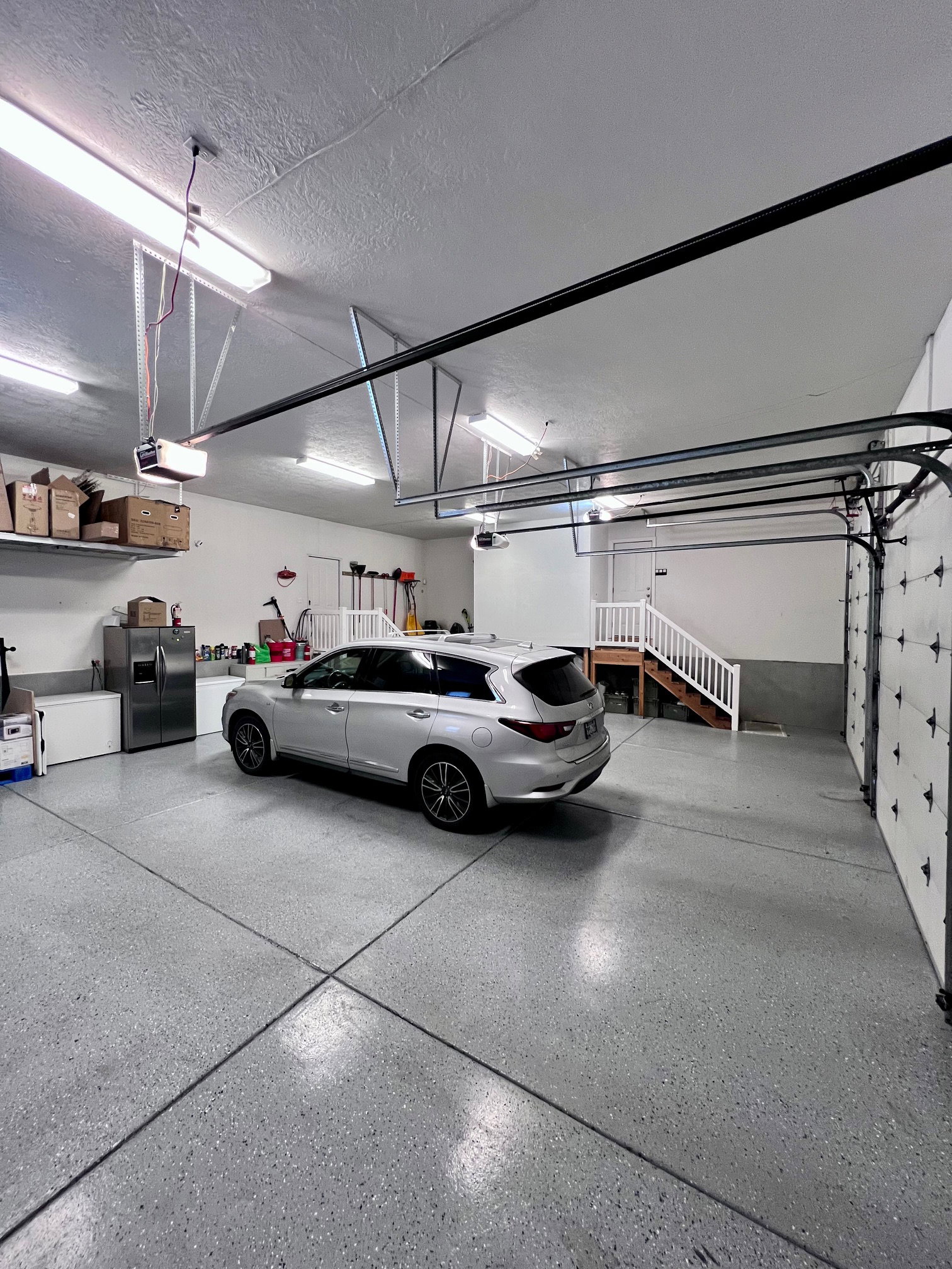 Spacious garage featuring a durable speckled epoxy floor finish