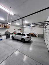 Spacious garage featuring a durable speckled epoxy floor finish