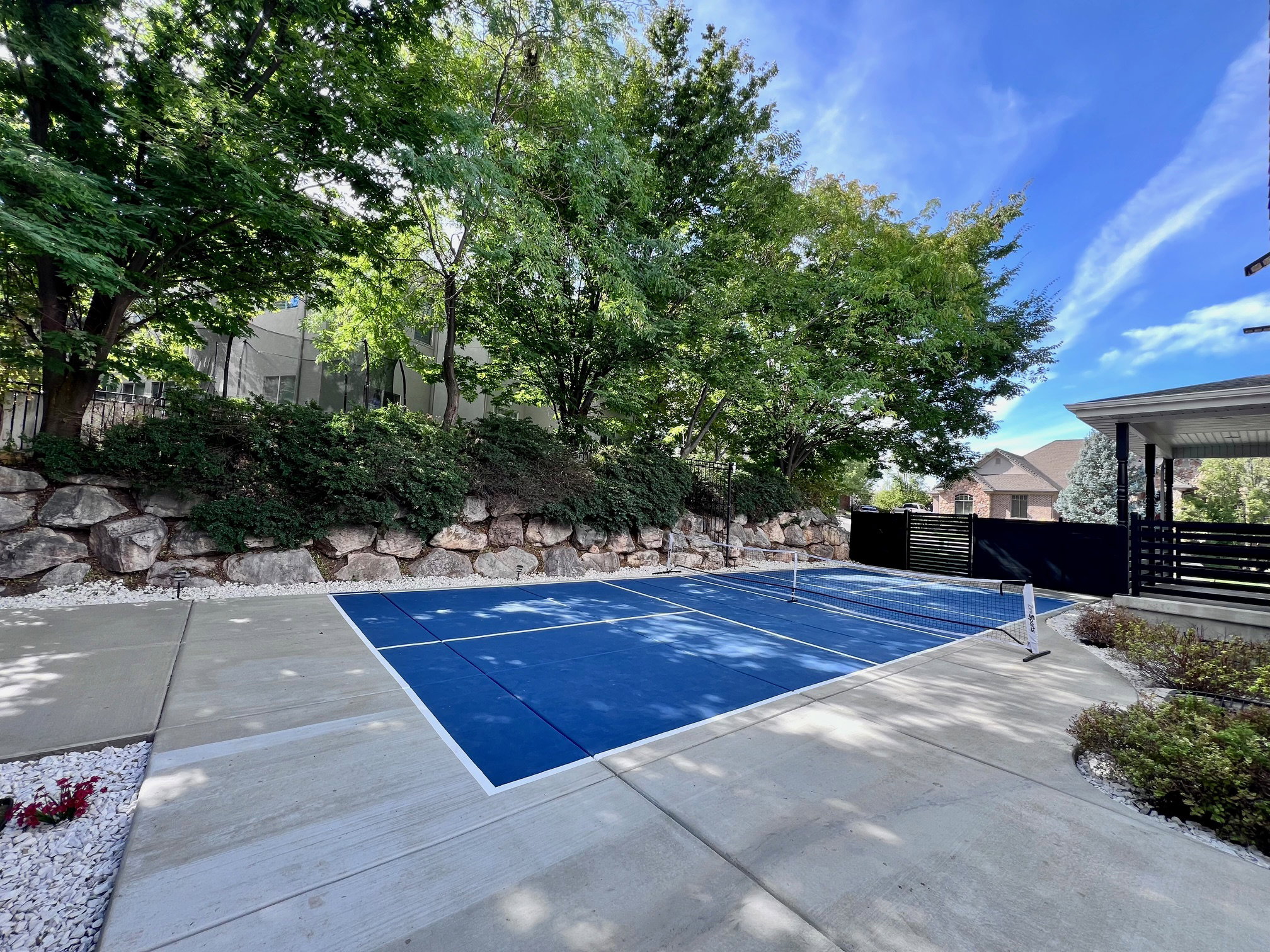 Outdoor sports court with a blue playing surface and white boundary lines