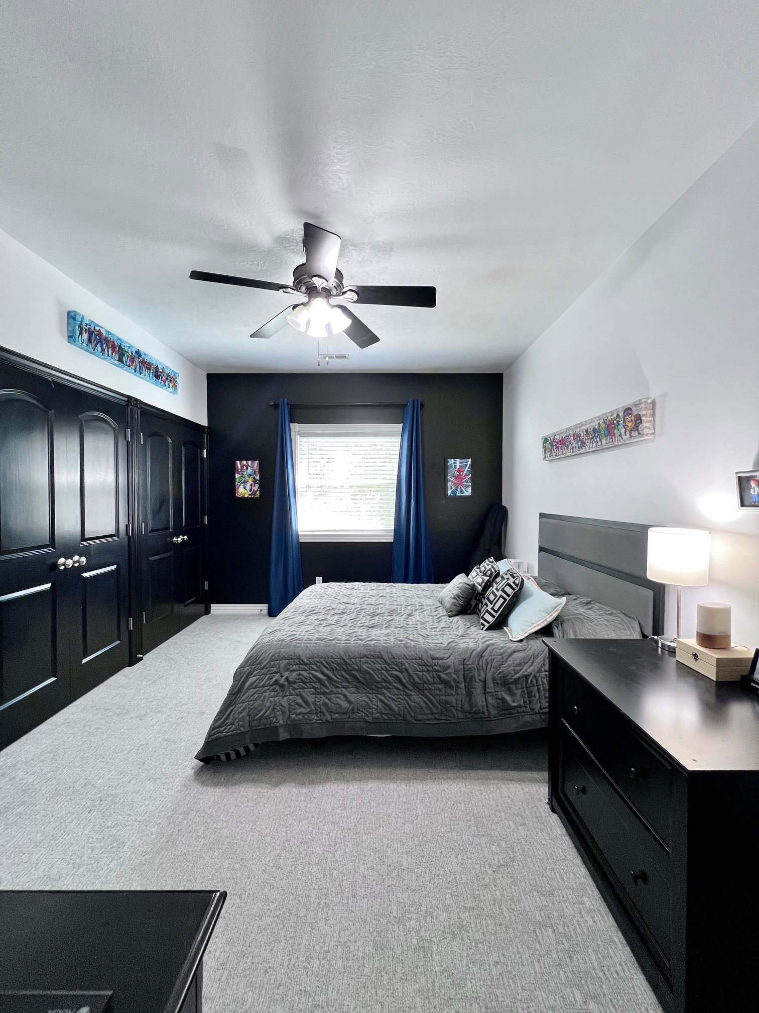Bedroom featuring light-toned carpeting, a window with blinds, and a ceiling fan with integrated lighting