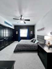 Bedroom featuring light-toned carpeting, a window with blinds, and a ceiling fan with integrated lighting