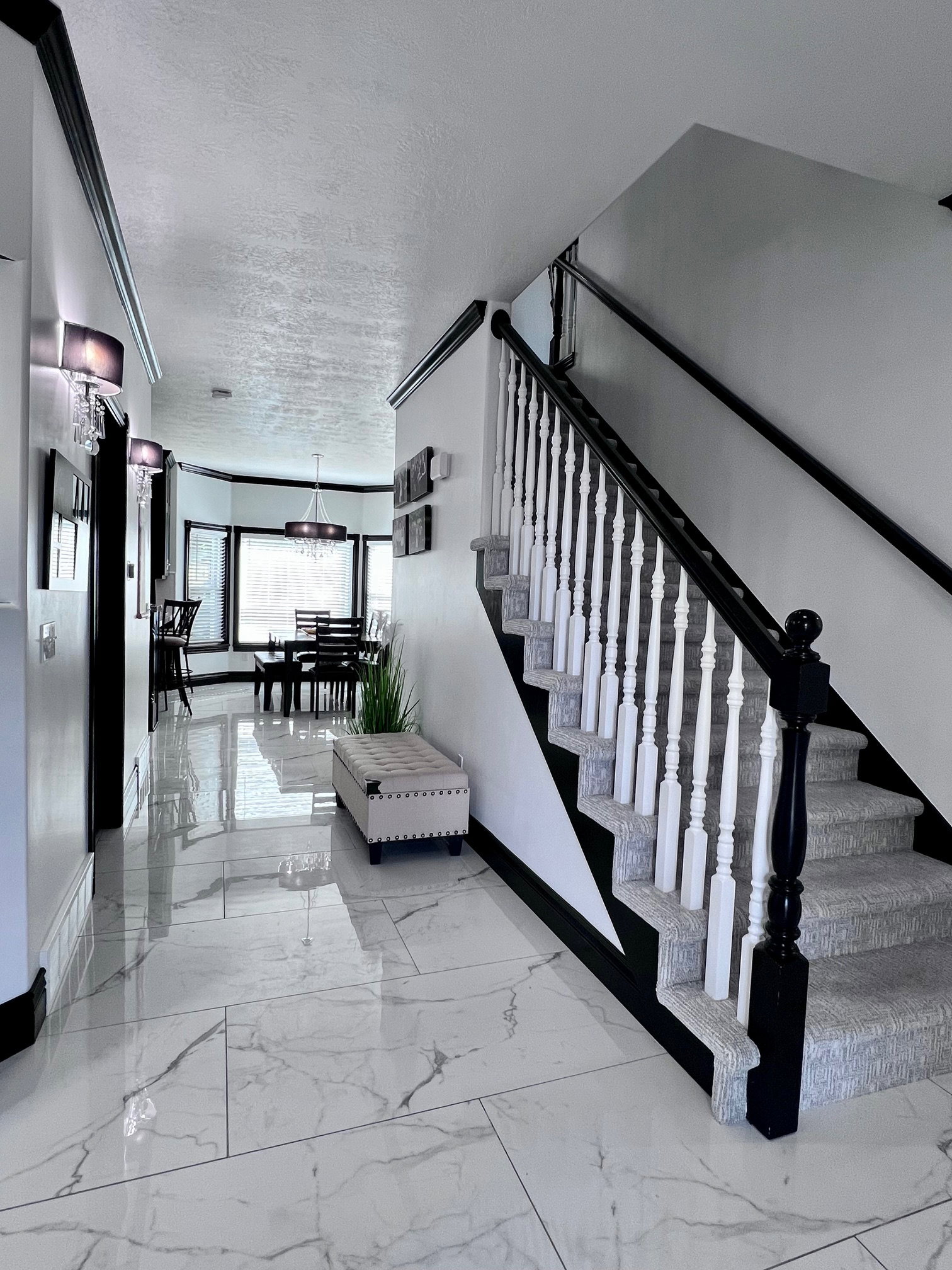 Grand entry featuring marble-look tile flooring