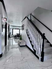 Grand entry featuring marble-look tile flooring