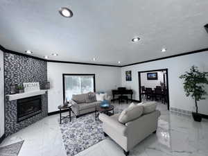 Spacious living area featuring large format white tile flooring, recessed ceiling lighting, and a fireplace with a mosaic tile surround and white mantel