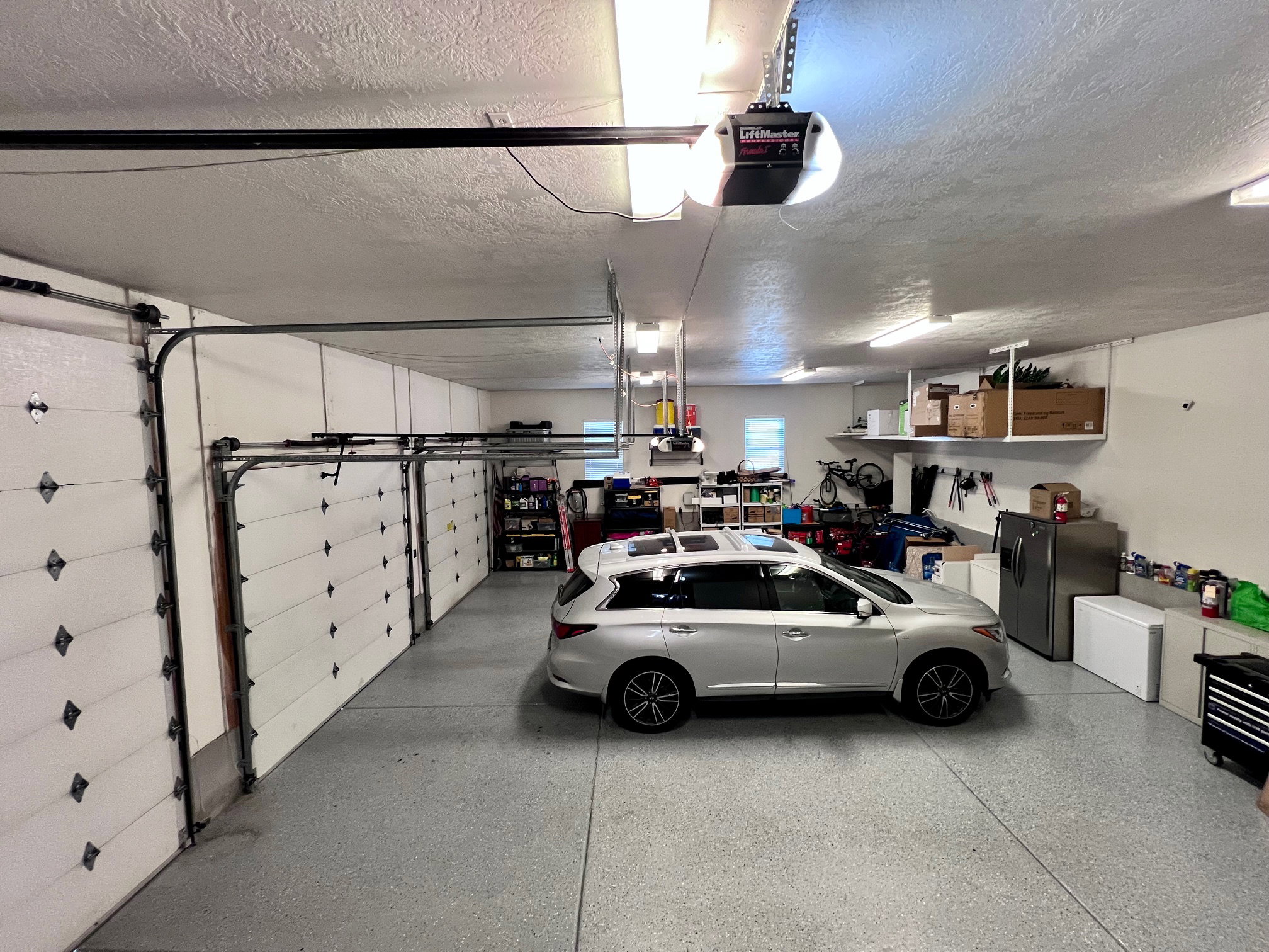 Multi-bay garage featuring a speckled epoxy floor finish