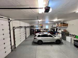 Multi-bay garage featuring a speckled epoxy floor finish