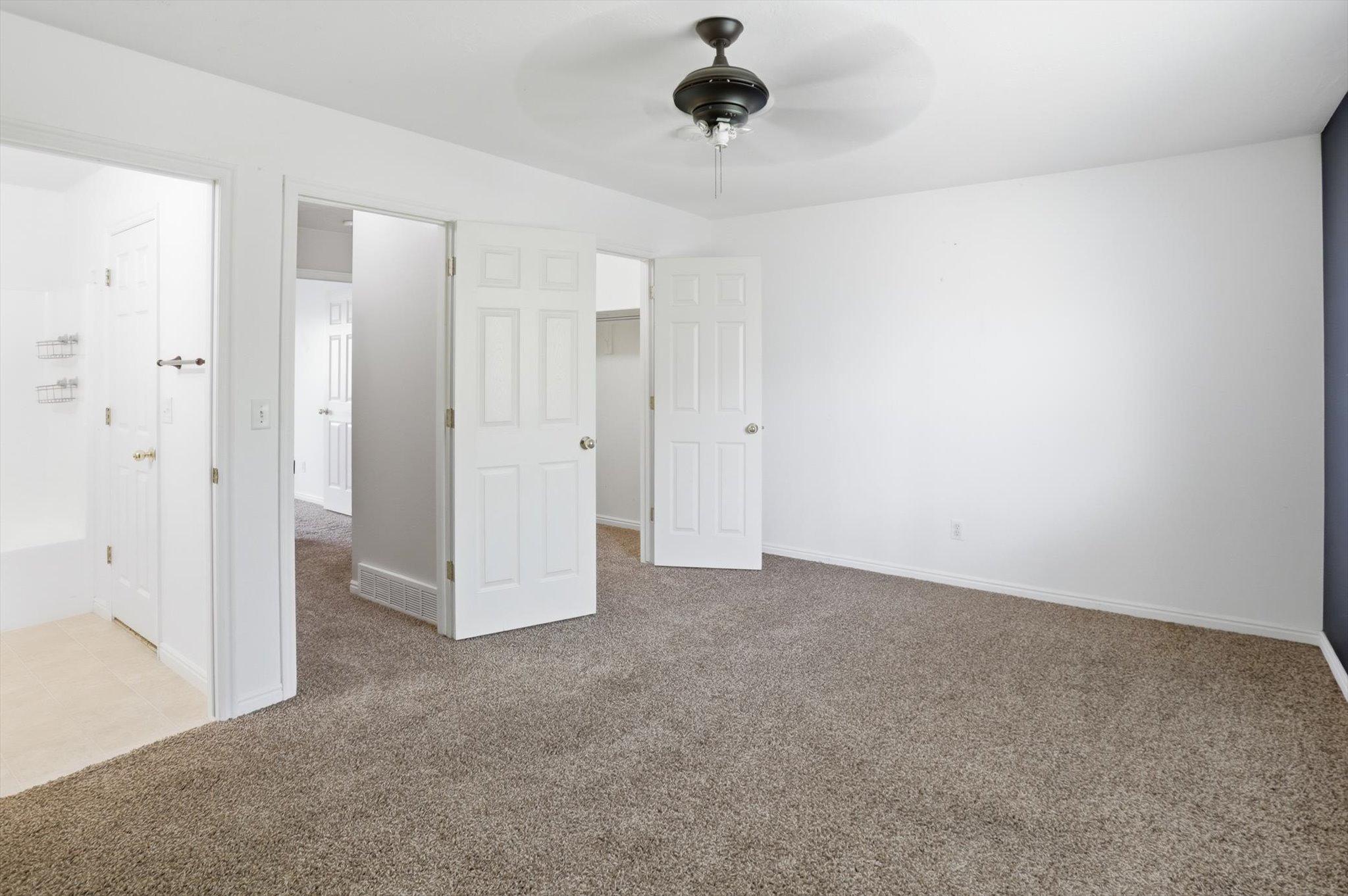 Carpeted room with white walls and a dark accent wall