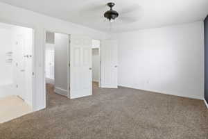 Carpeted room with white walls and a dark accent wall