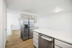 Modern kitchen with light-toned cabinetry and stainless steel appliances