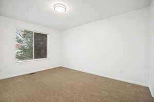Master upstairs bedroom. Bright interior space with a window featuring horizontal blinds
