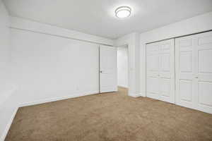 Front downstairs bedroom featuring double wide closet with bi-fold doors