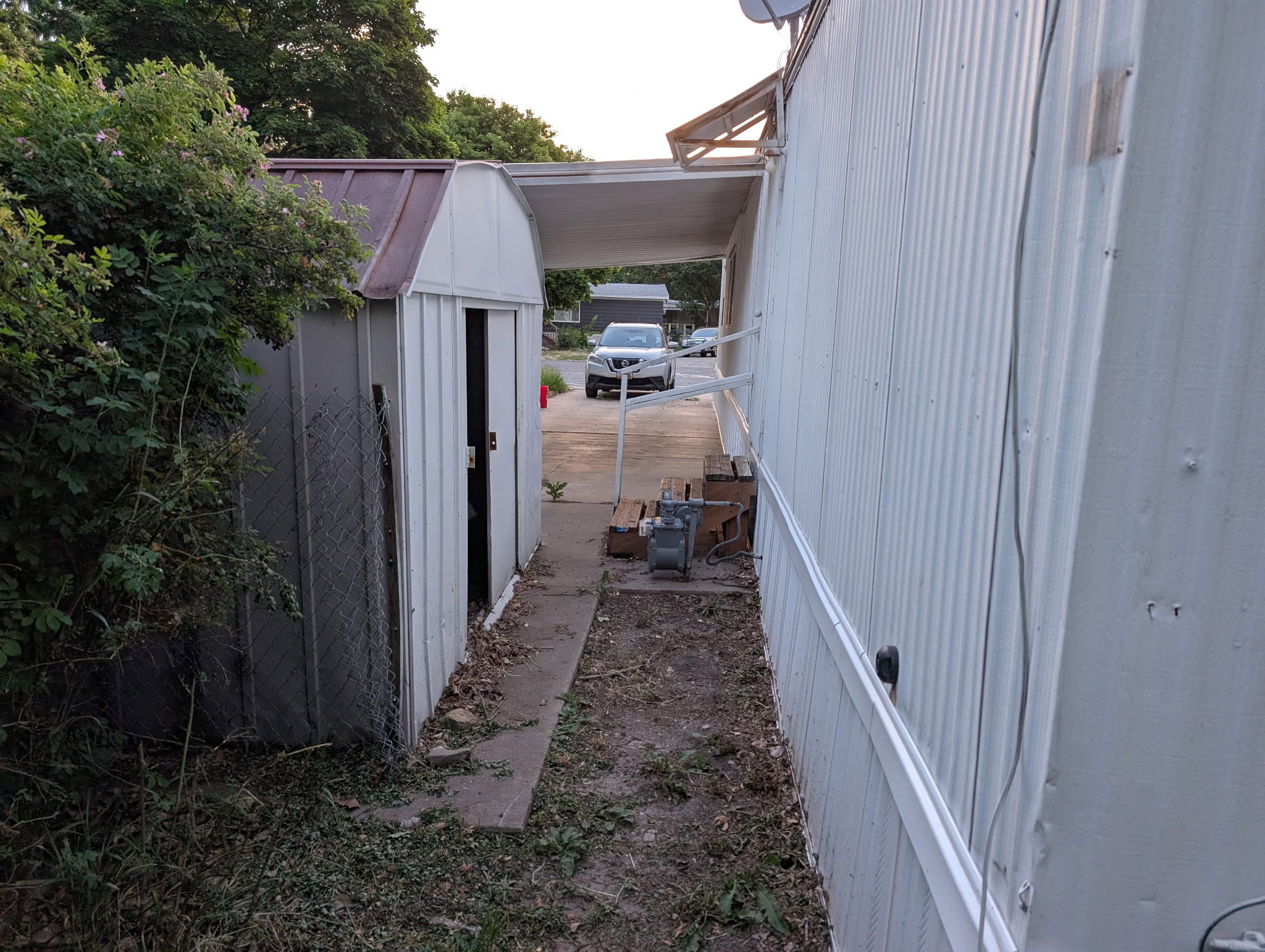 Detached storage shed with a brown metal roof
