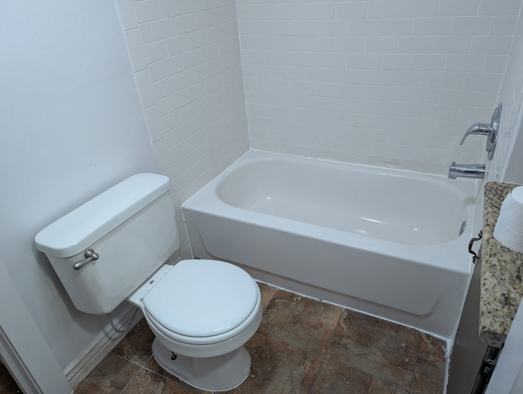 Full-size bathtub with subway tile surround