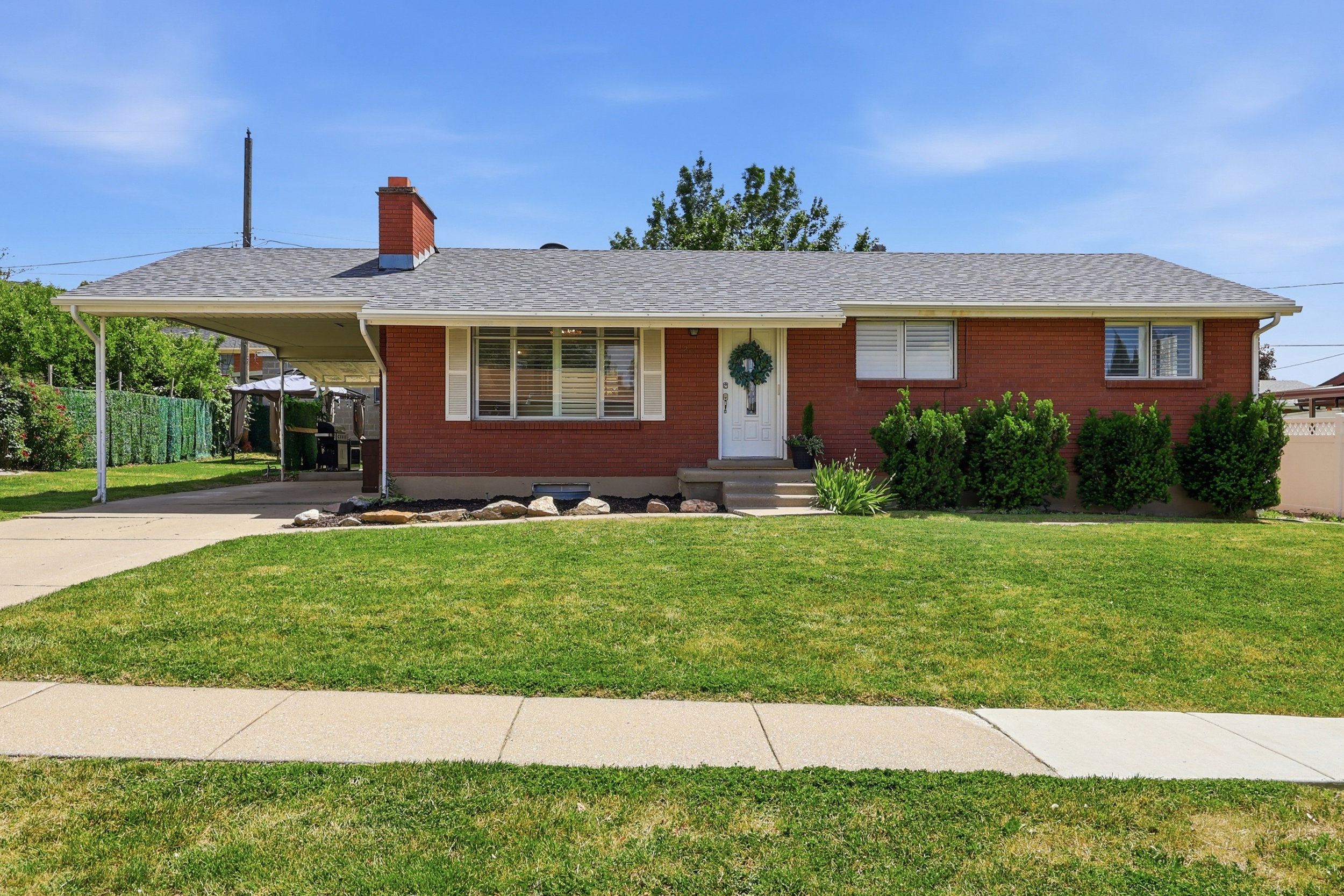 Brick exterior featuring a gabled roof and white trim