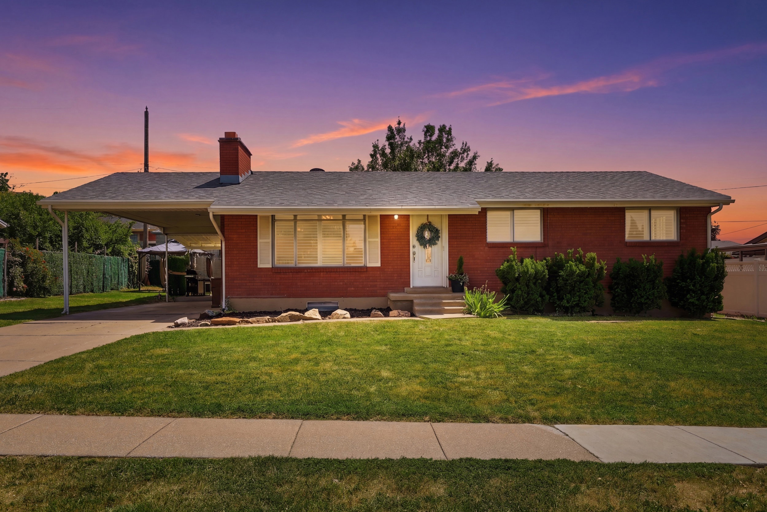 Brick exterior with an attached carport