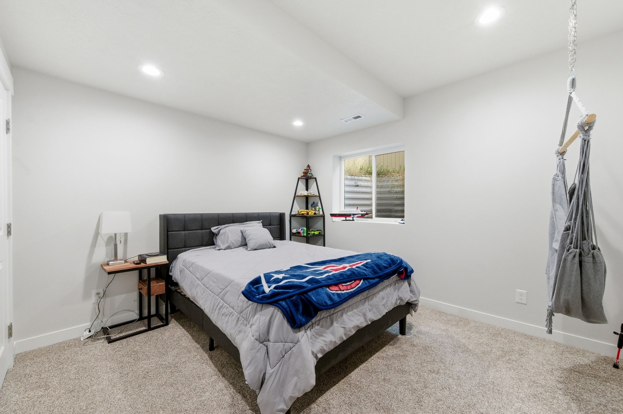 Carpeted room featuring a single window, white walls, and recessed lighting