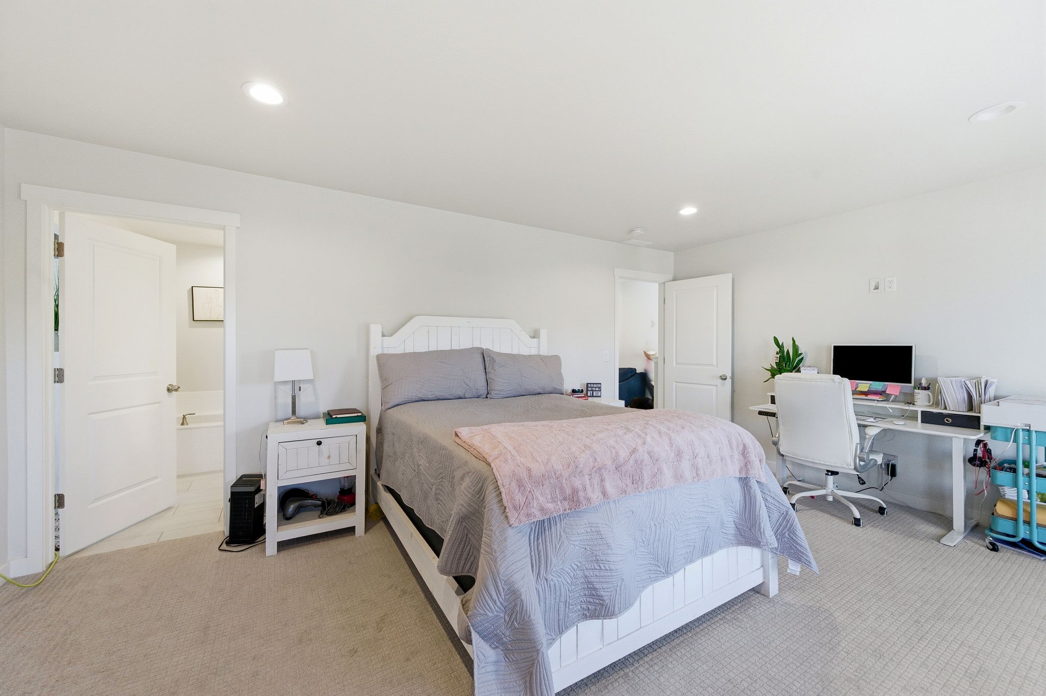Spacious bedroom featuring neutral wall paint, recessed lighting, and soft carpet flooring