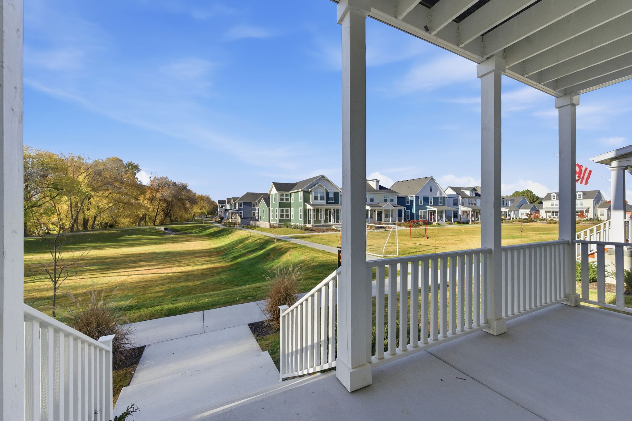 Covered porch with white railings and columns
