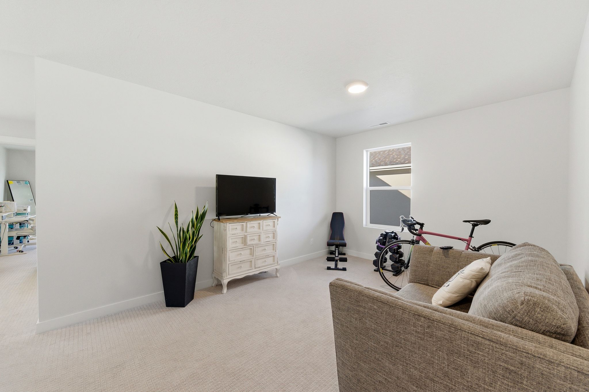 Carpeted room featuring a single window and recessed lighting