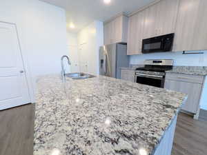 Kitchen island with a stainless steel sink and gooseneck faucet