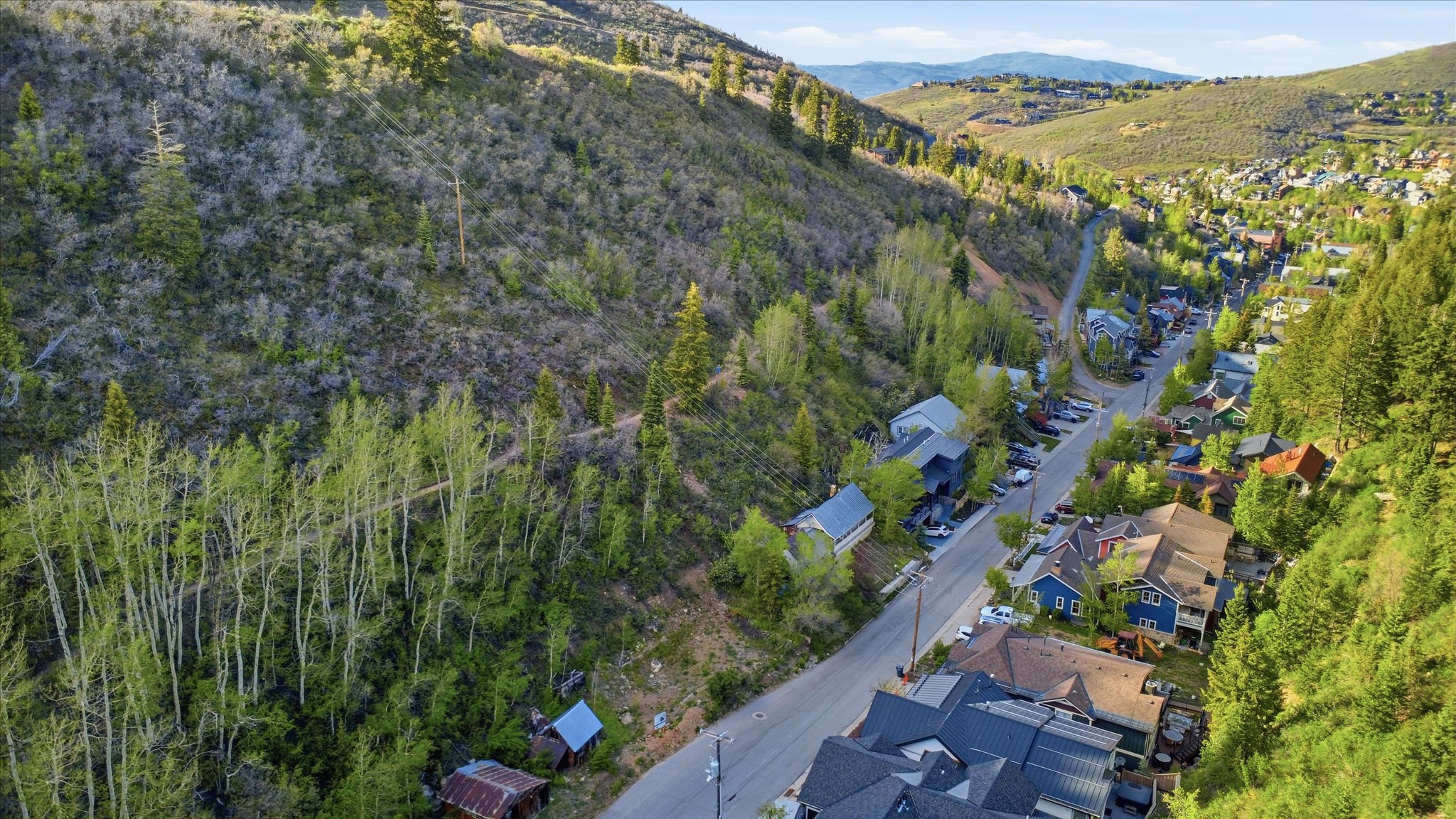 Mountainous terrain with natural vegetation surrounding a residential area