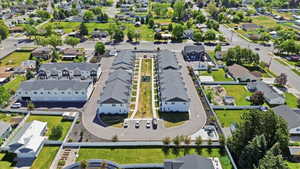 Modern multi-unit property with light-toned exteriors and dark roofing