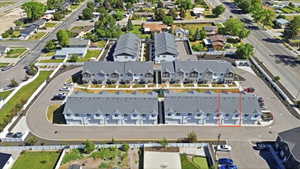 Contemporary townhome development featuring multiple units with individual garages and a shared paved driveway
