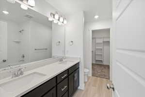 Double vanity with undermount sinks, chrome fixtures, and a light-toned countertop