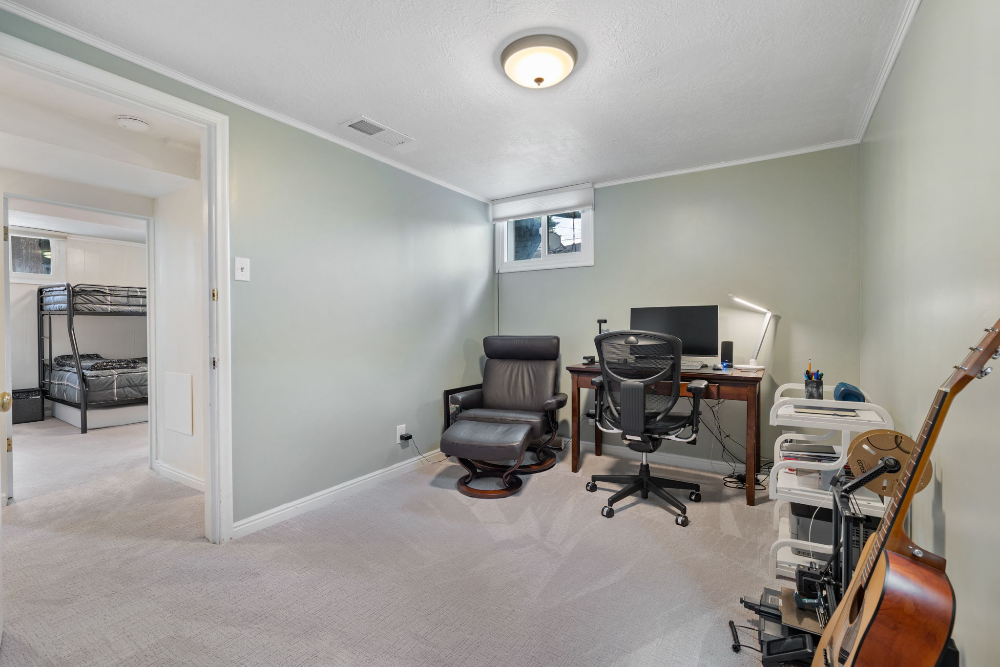 Carpeted room with a ceiling light fixture and a window
