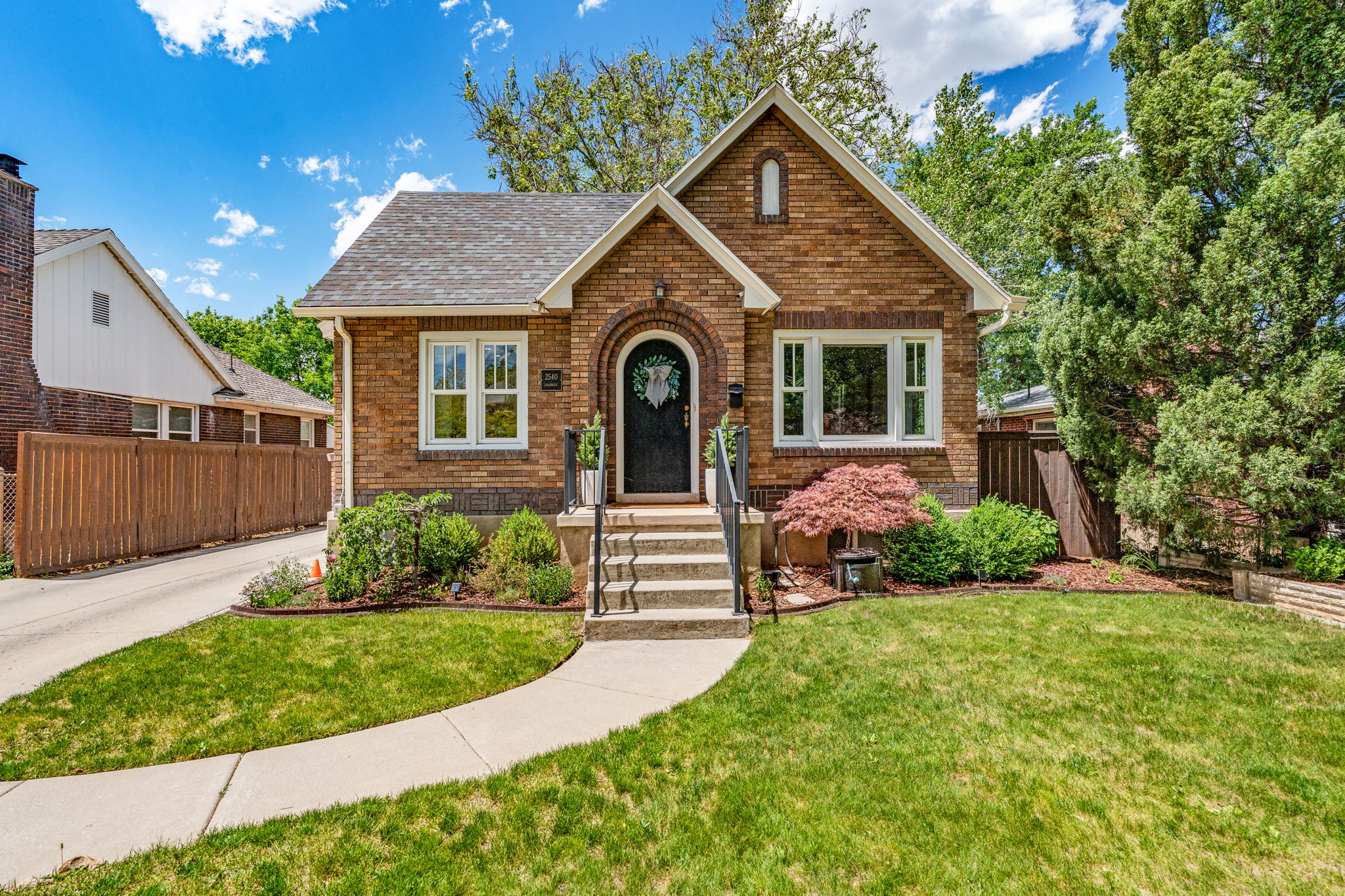Brick exterior featuring a gabled roofline and arched entry