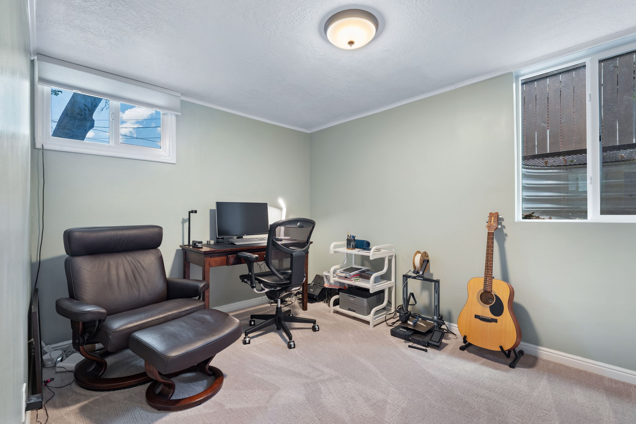 Carpeted room with light green walls and white trim