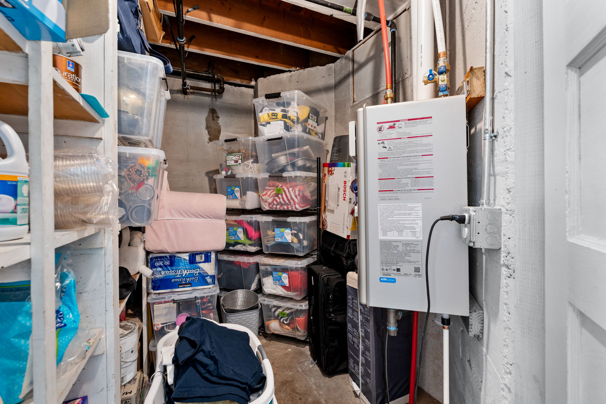Tankless water heater installation on a concrete wall
