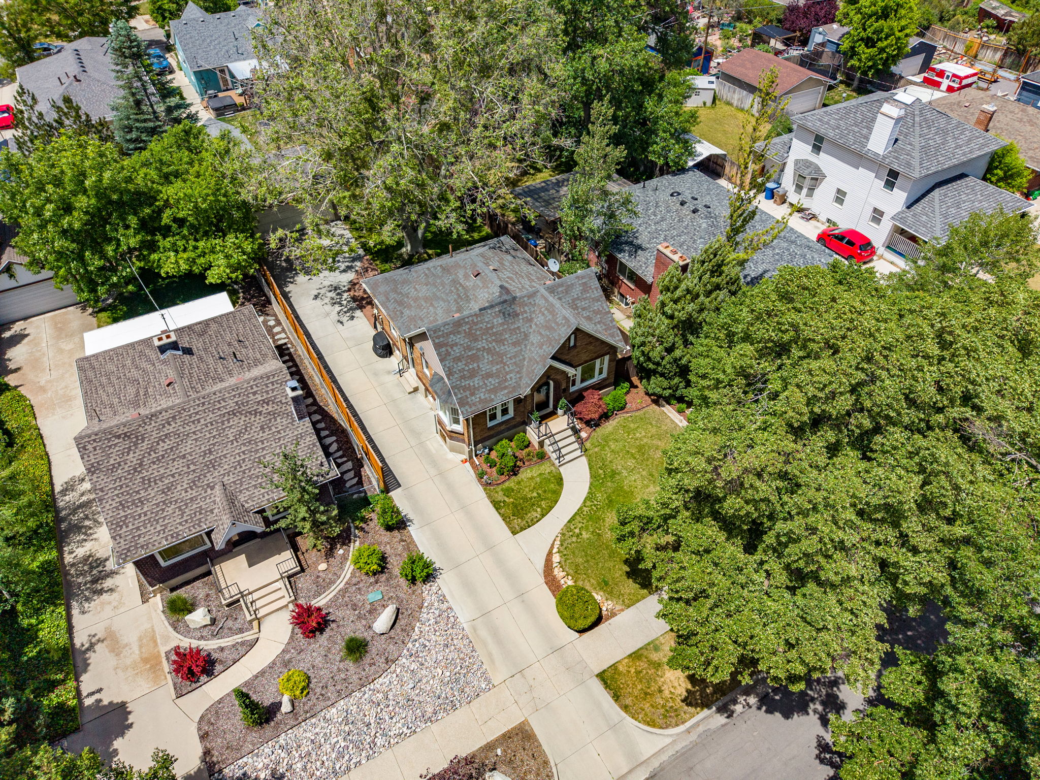 Residential property featuring a deep brown exterior and dark shingle roof