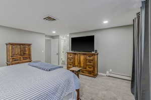 Carpeted bedroom with neutral gray walls and recessed lighting