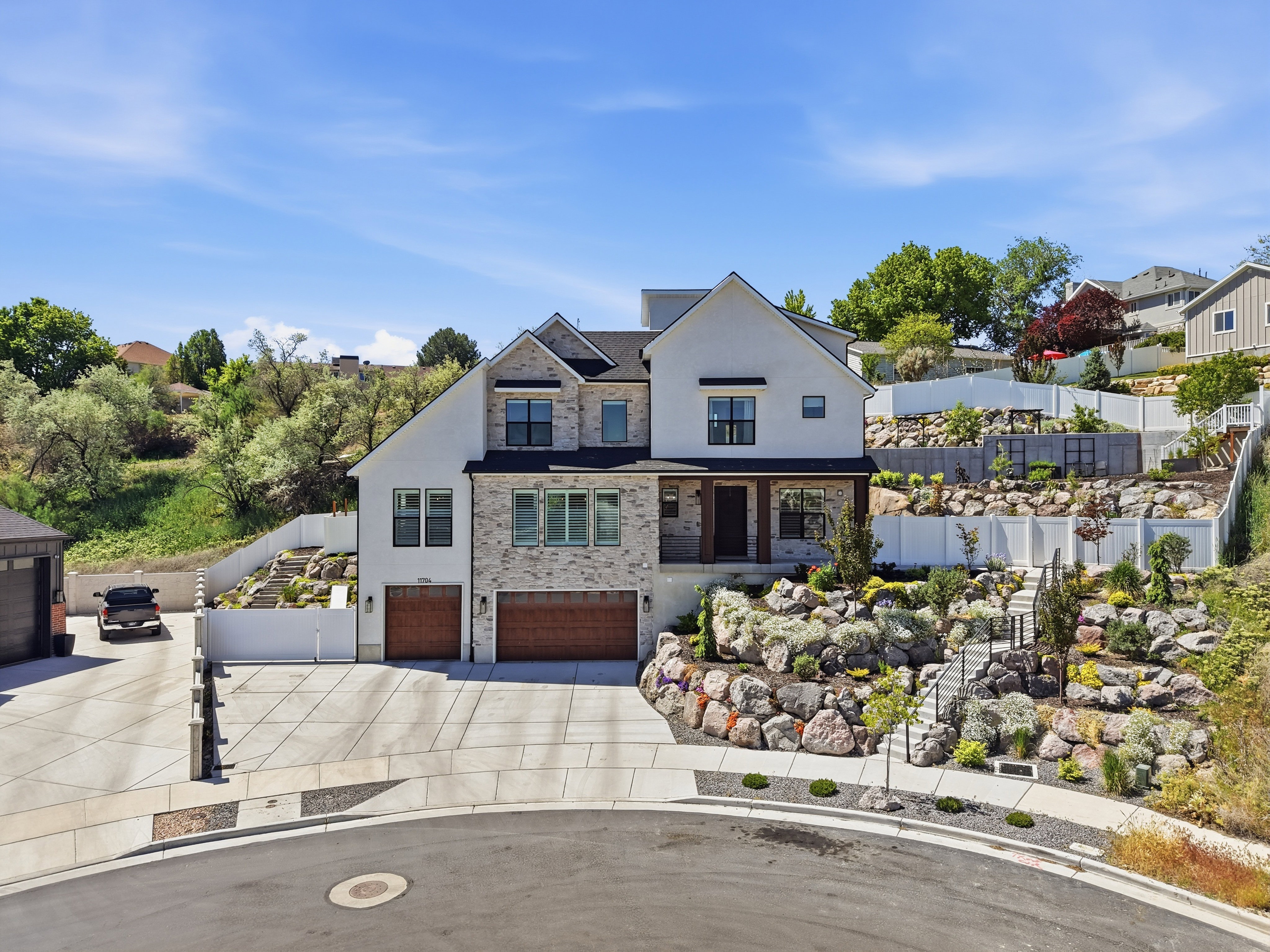 Stately two-story residence featuring a stone and stucco exterior