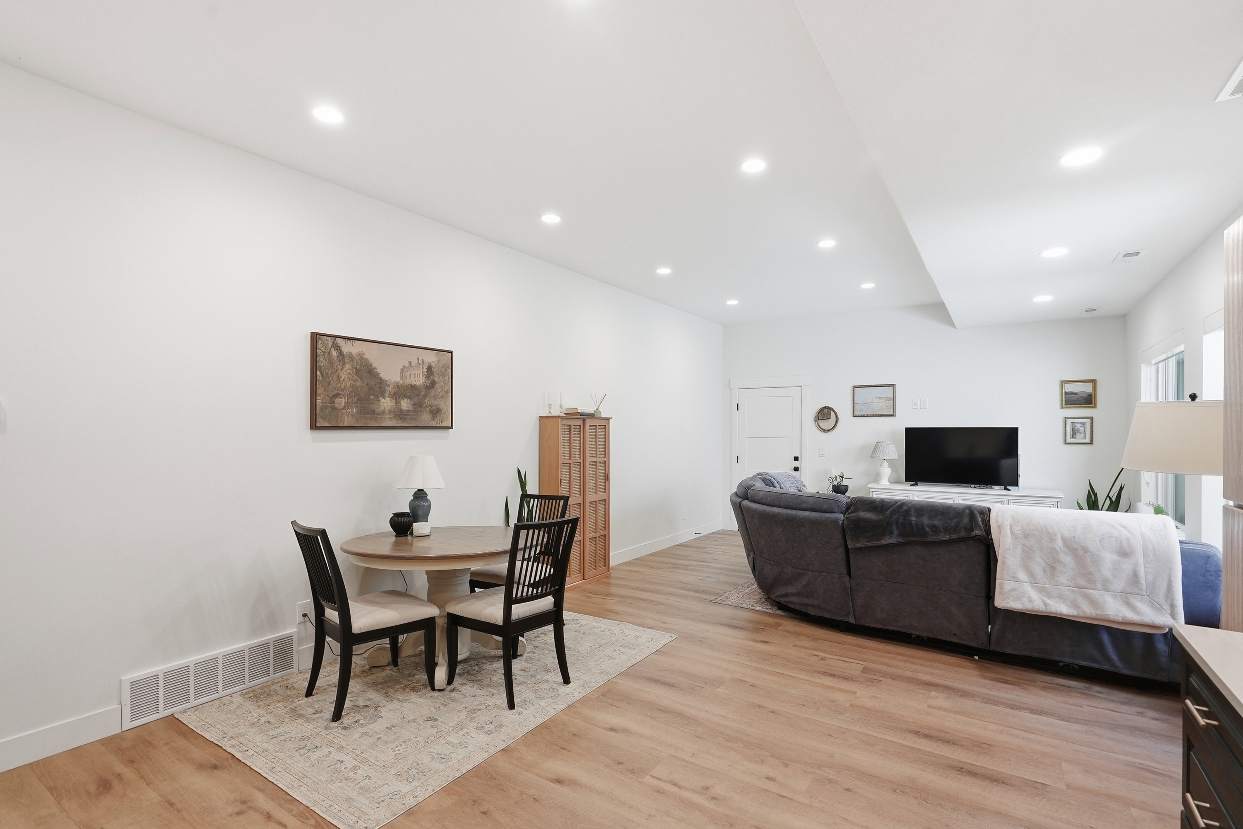 Bright interior space featuring LVP flooring, recessed lighting, and white walls