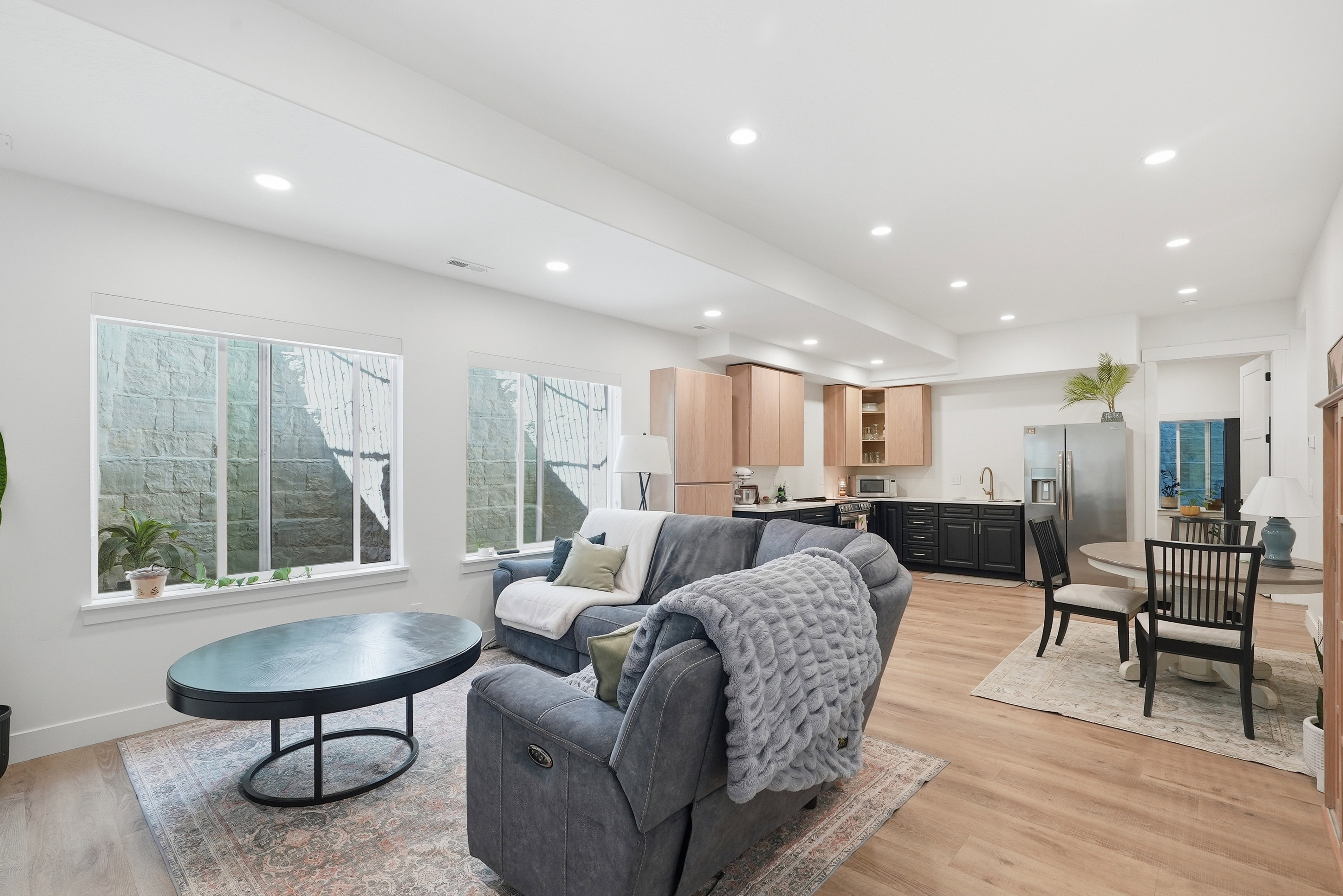 Open-concept living space featuring recessed lighting, LVP flooring, and white walls