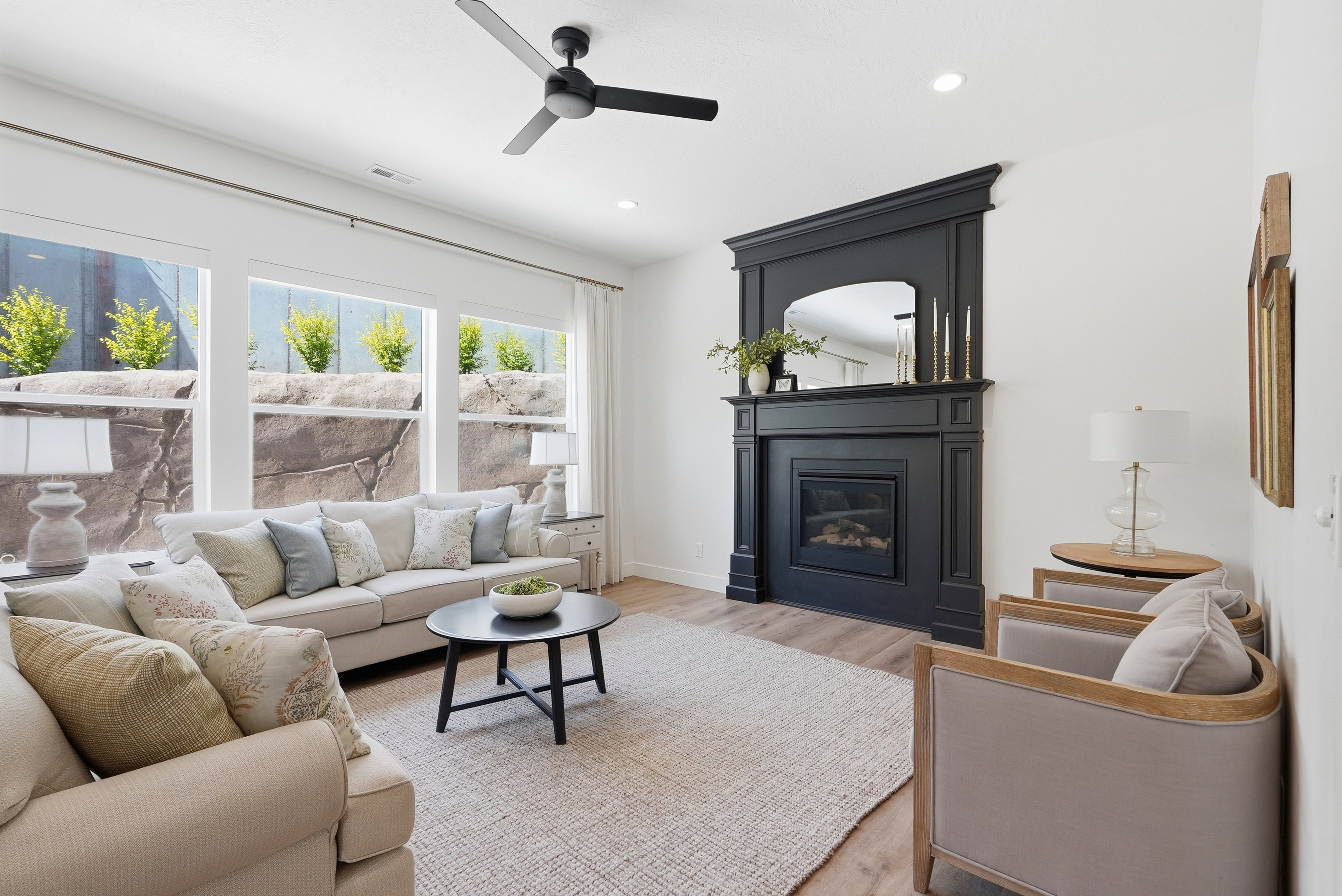 Spacious living area featuring a decorative dark mantel with an embedded fireplace