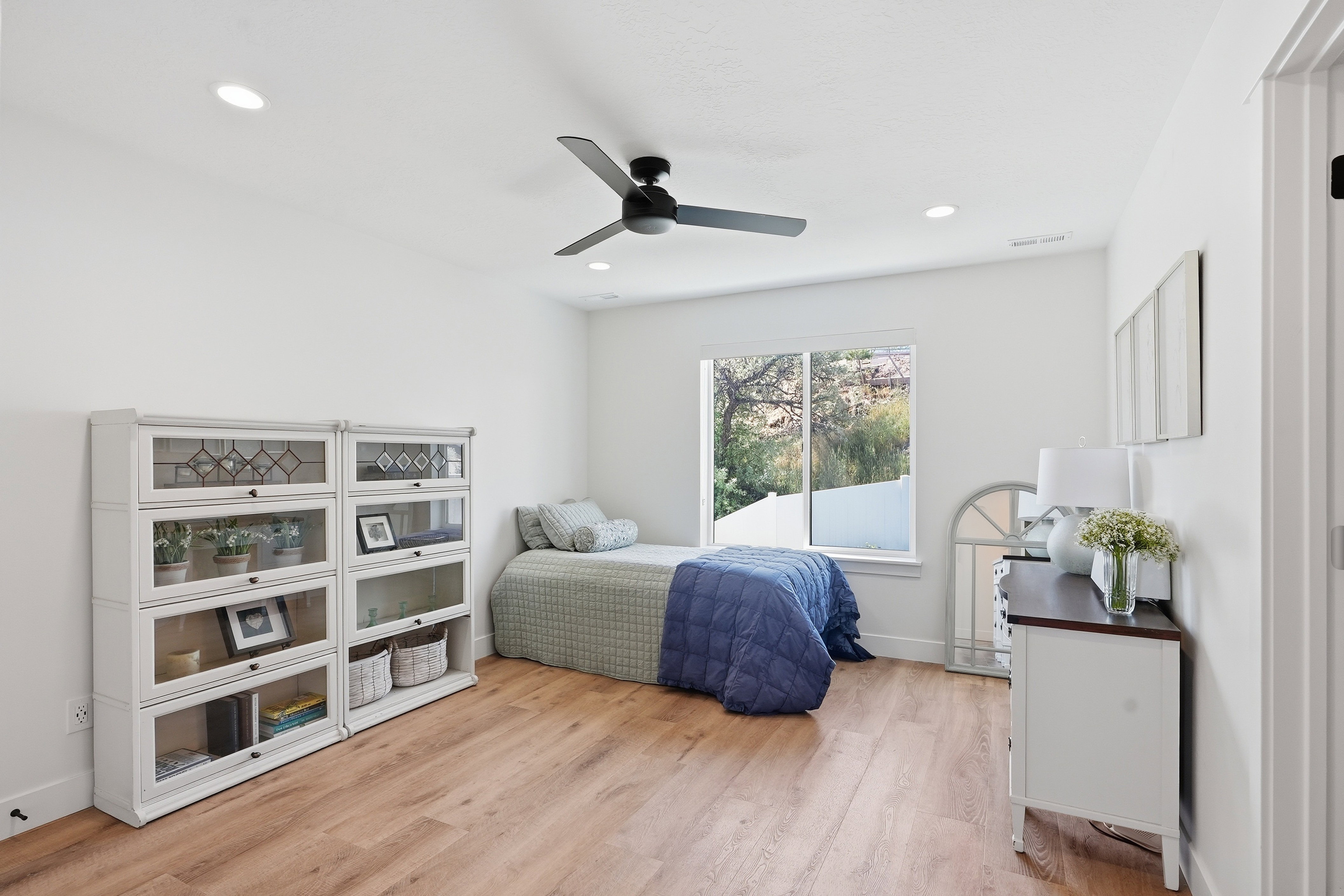 White walls complement LVP flooring in this room featuring a large window