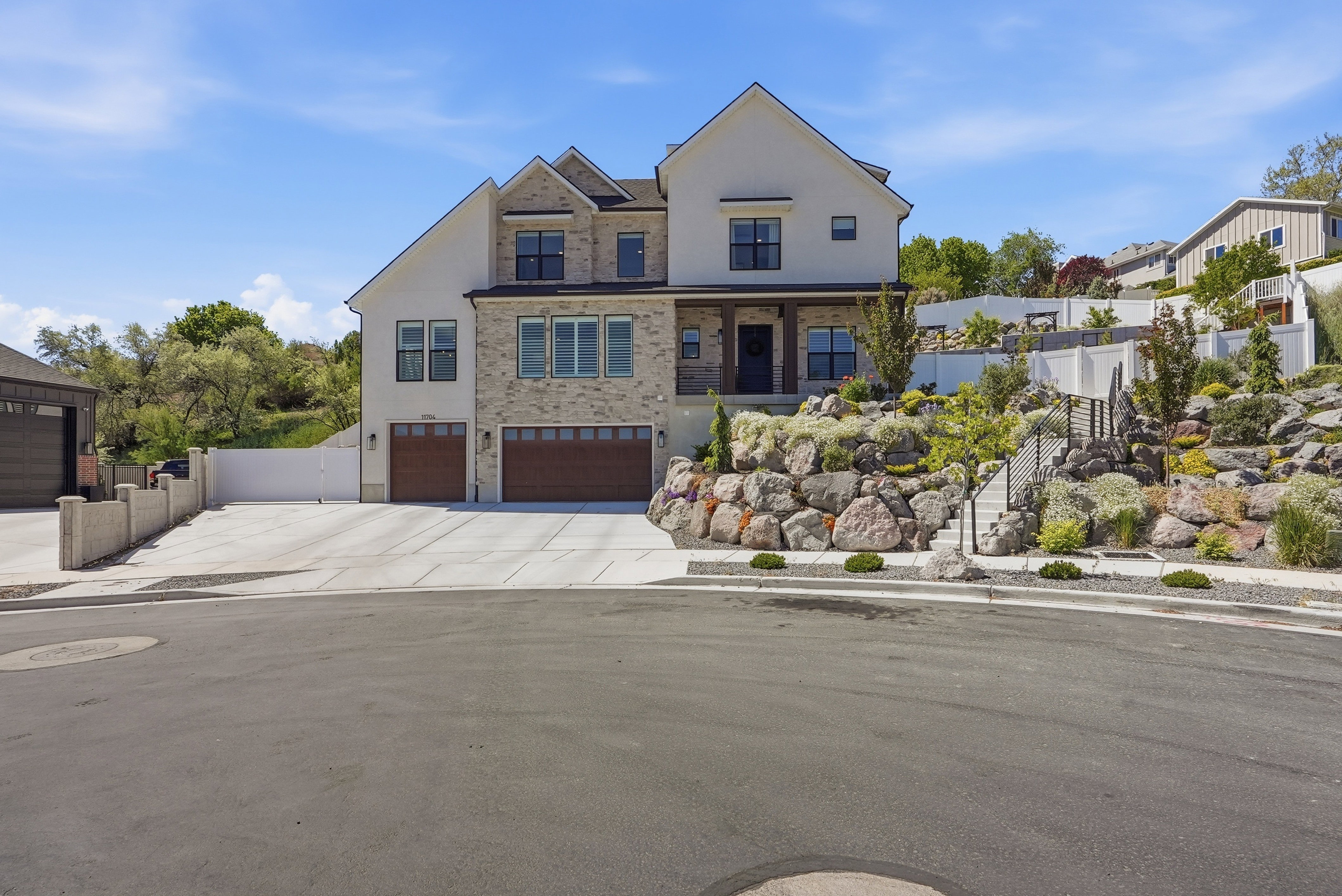 Stately two-story residence featuring a stone and stucco exterior