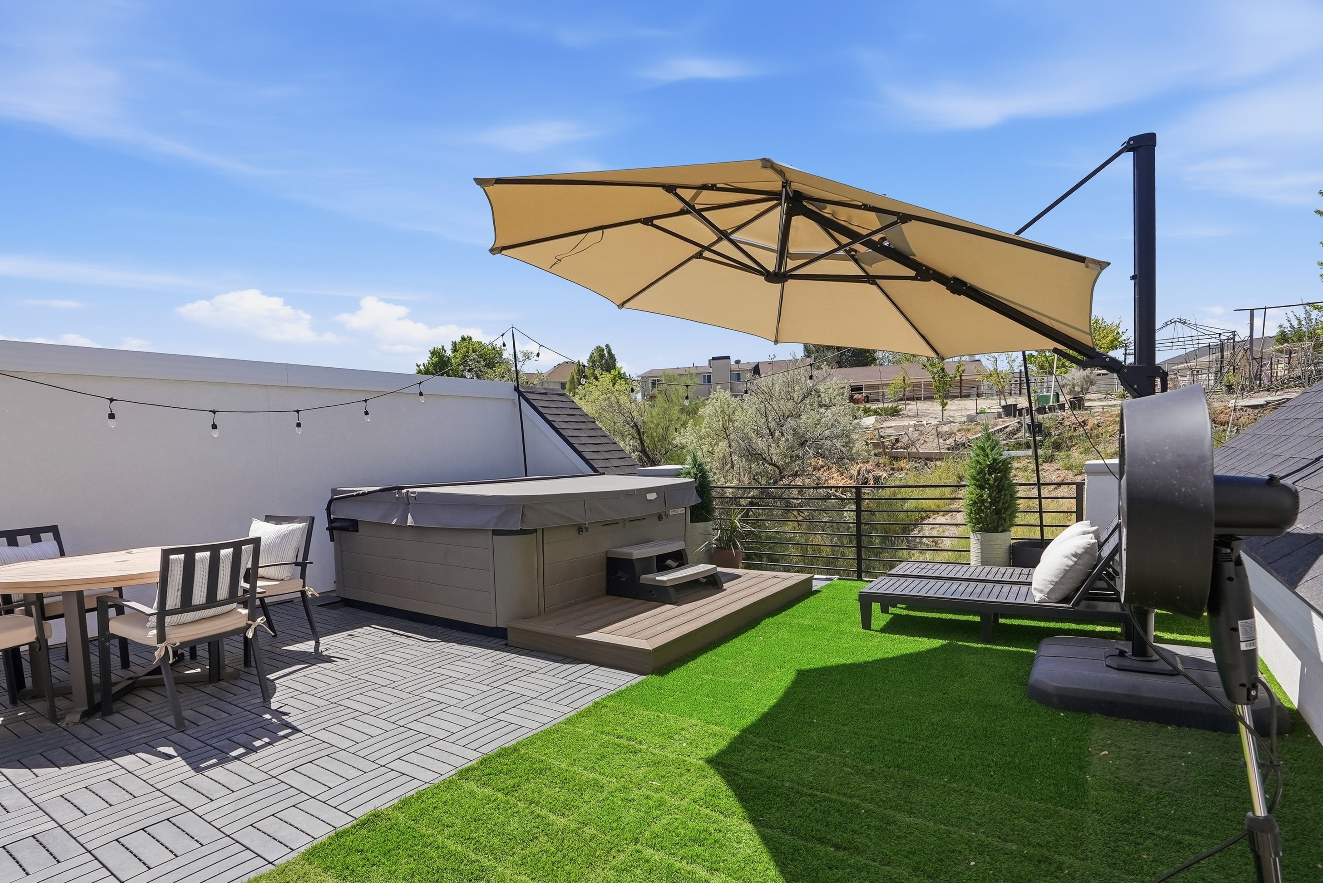 Rooftop patio featuring a built-in hot tub with Tex Step, artificial turf area,