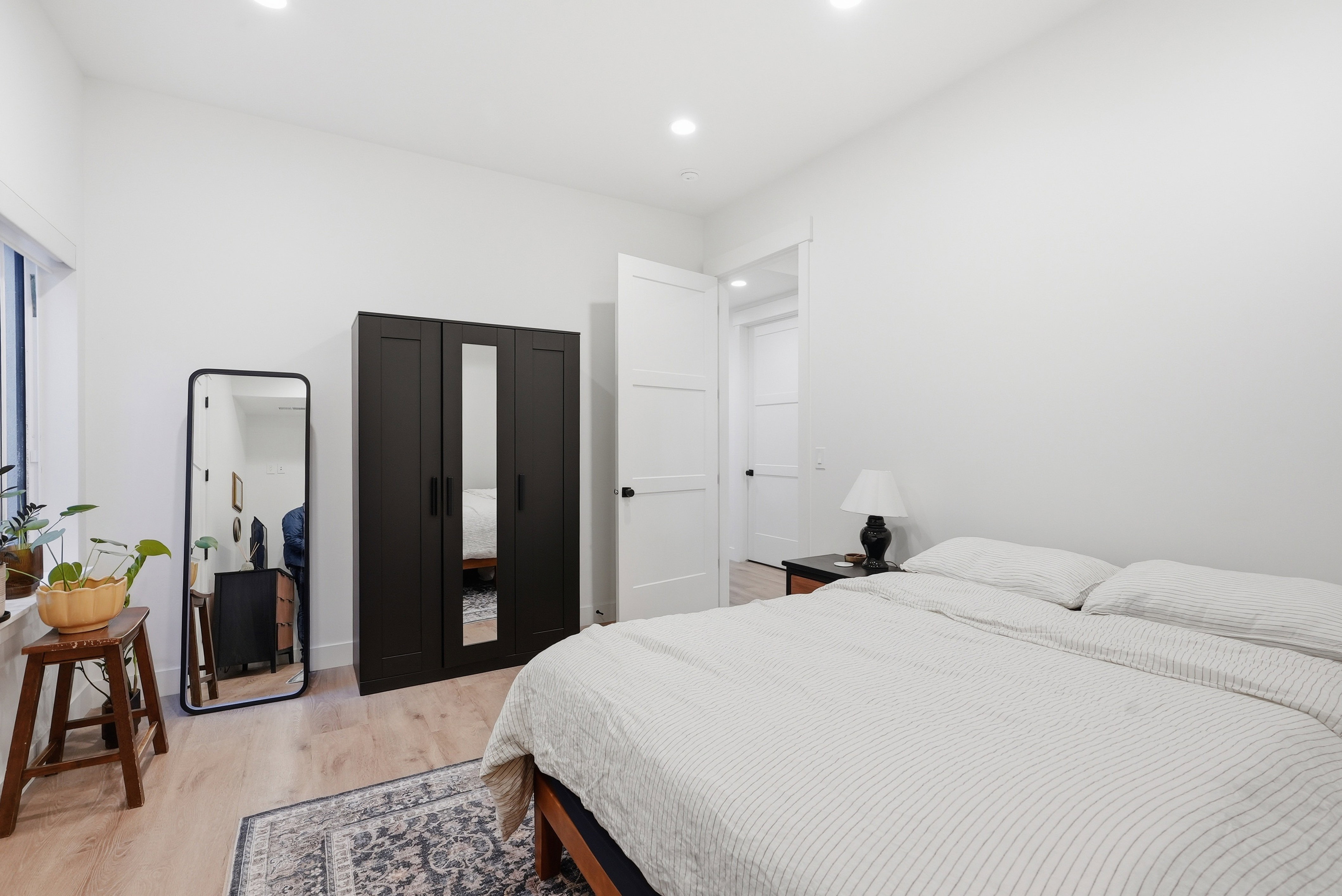 Light LVP flooring complements the bright white walls and recessed ceiling lighting
